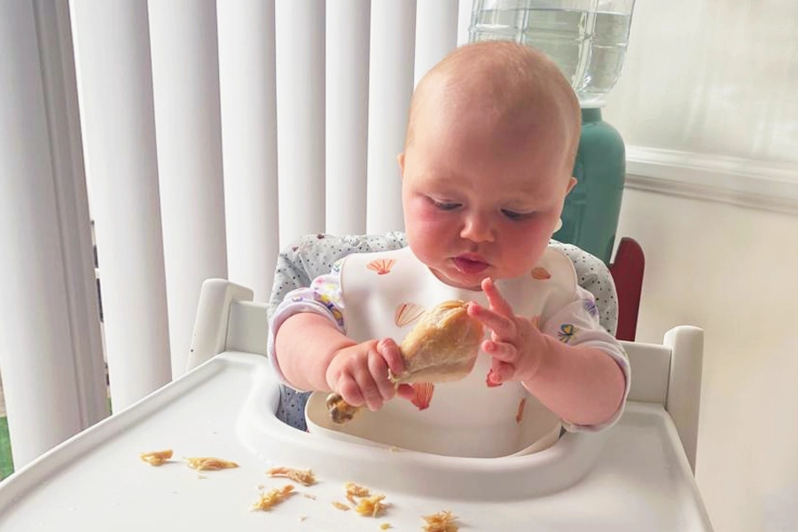 Baby eating drumstick