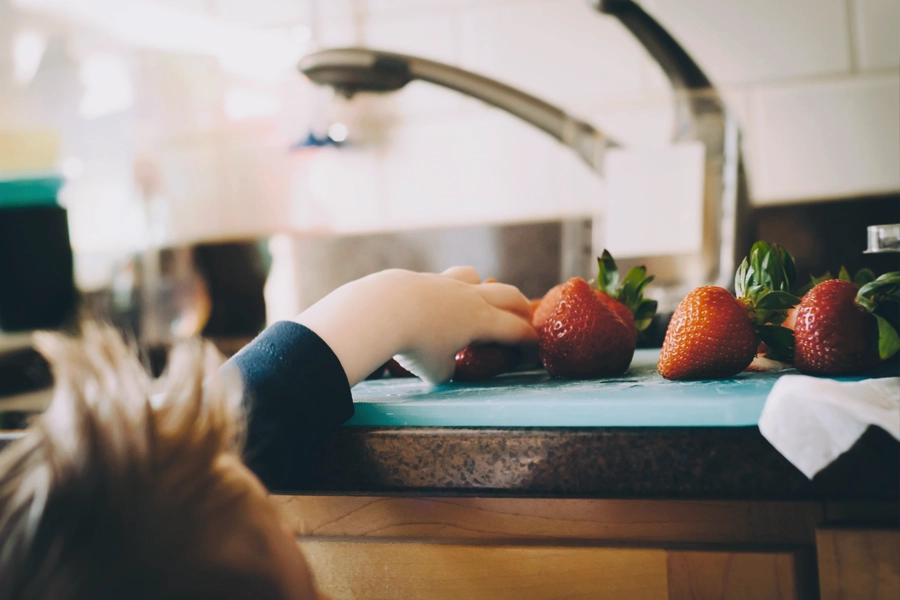 Child taking strawberry